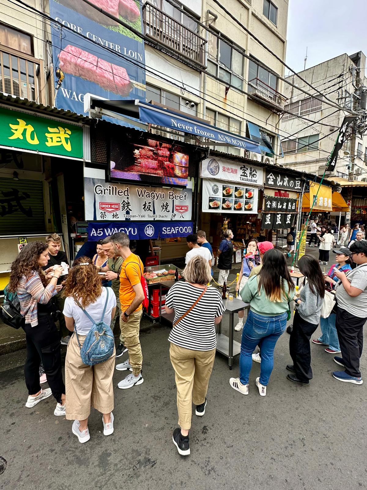 Travelers and guides at Tsukiji Market, where WabiSabi began