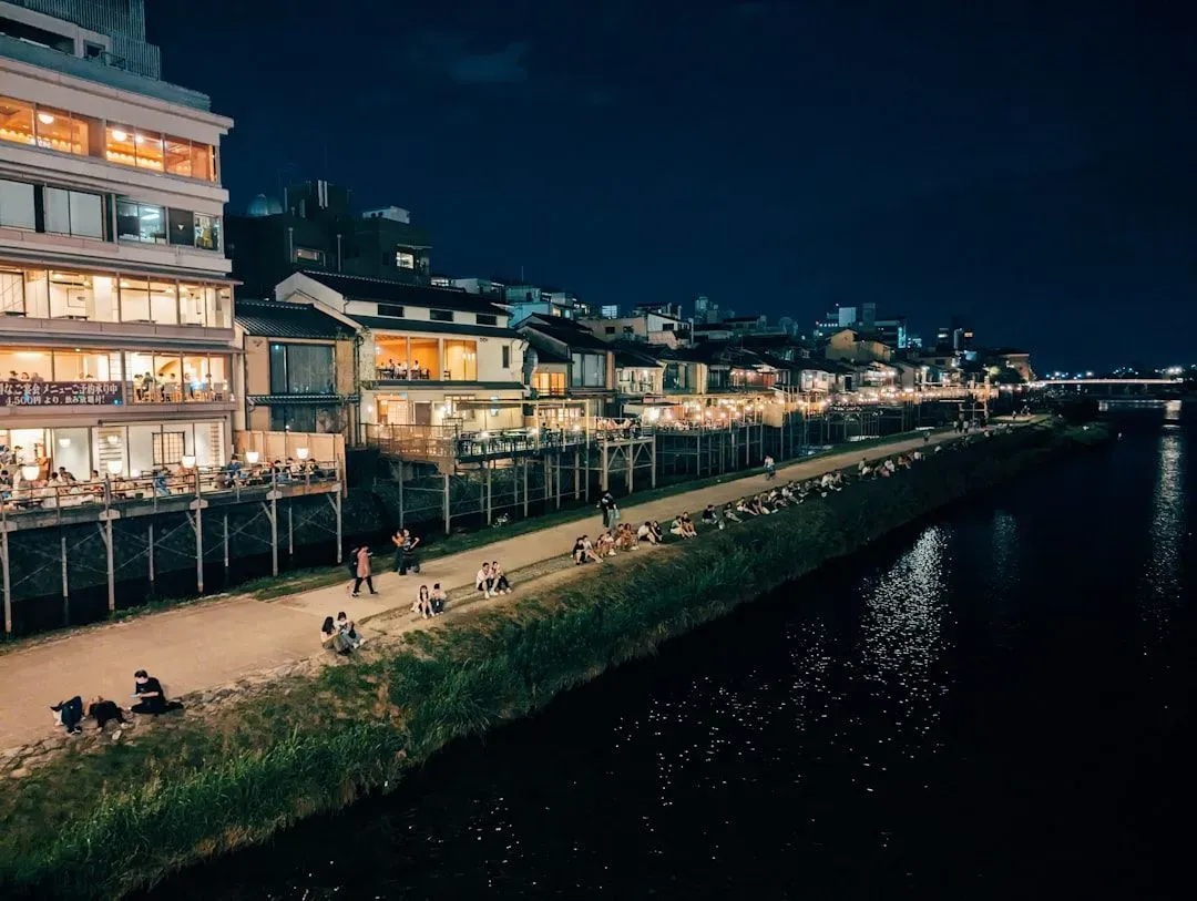 A city at night with a river running through it