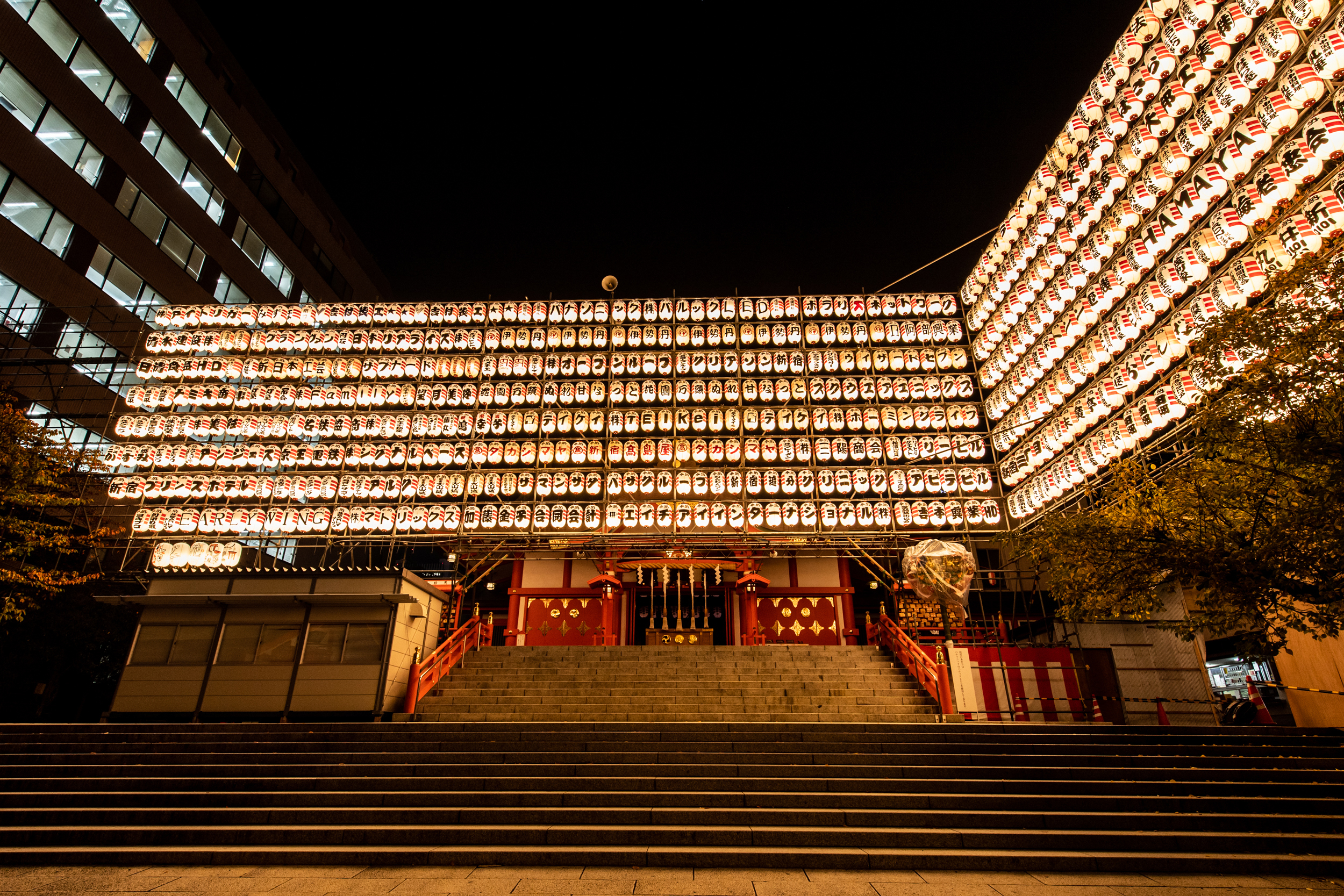 Crowds and food stalls at Hanazono Shrine during the night fair in Shinjuku